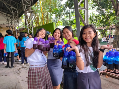 students assisting the events by distributing water bottles donated by forgiven much